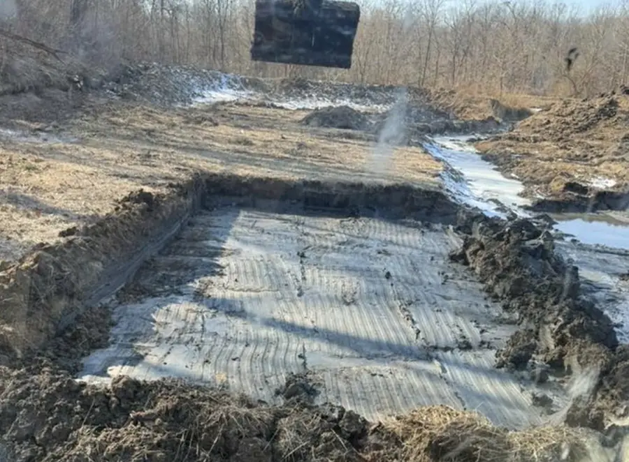 Excavated cut with stone base going in