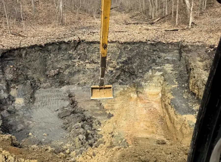 Excavator cutting a deep footing