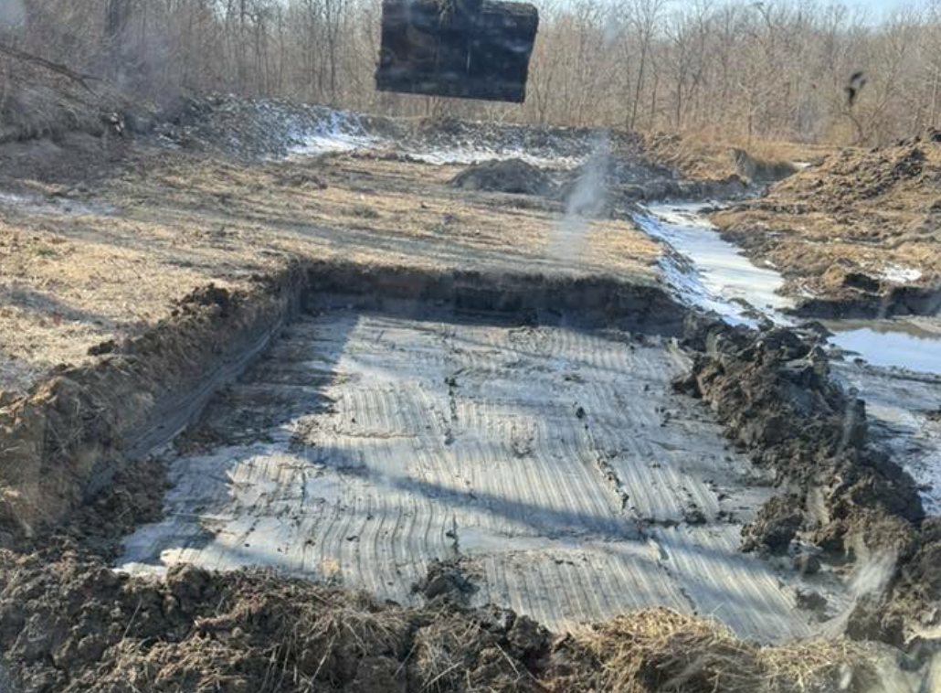 Excavated cut with stone base going in