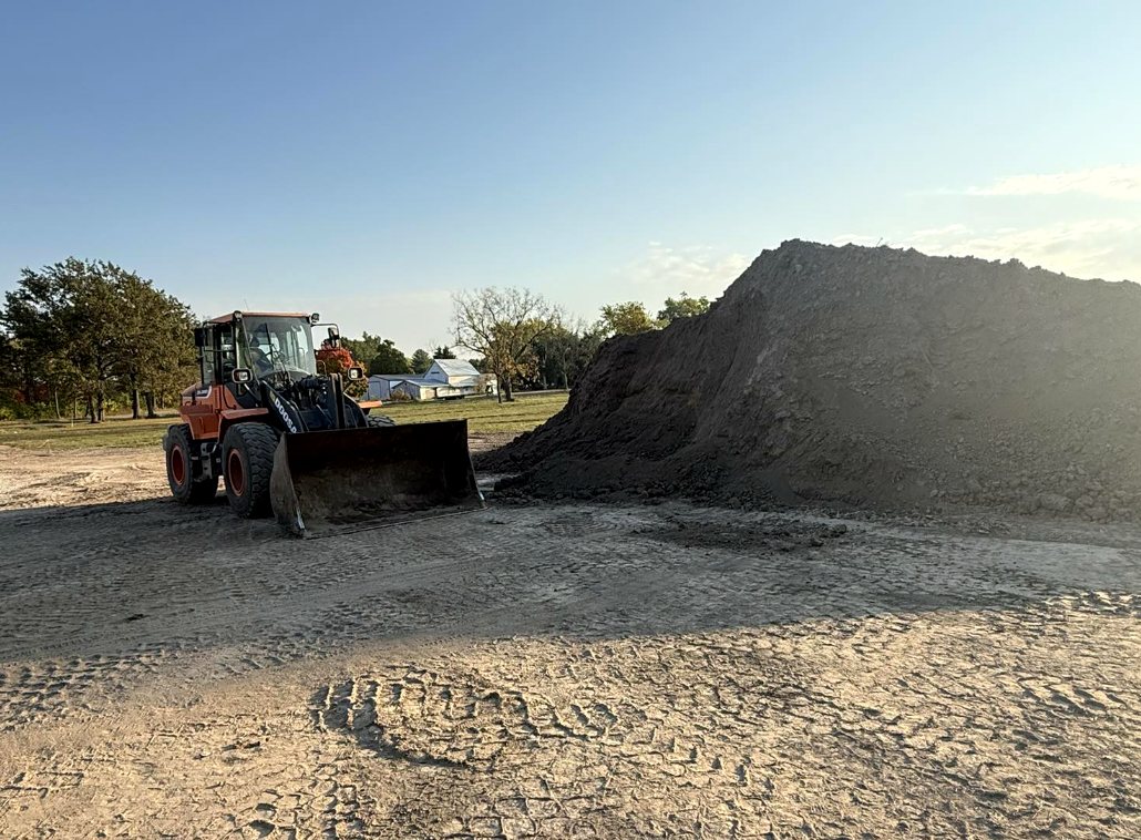 Wheel loader working a dirt stockpile