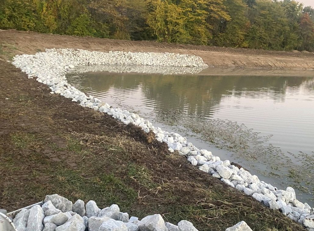 Pond bank finished with rip-rap stone