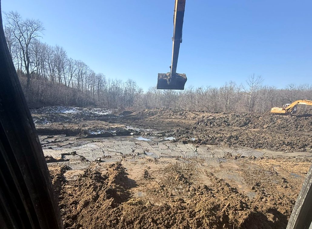 Excavator working a large earthwork cut